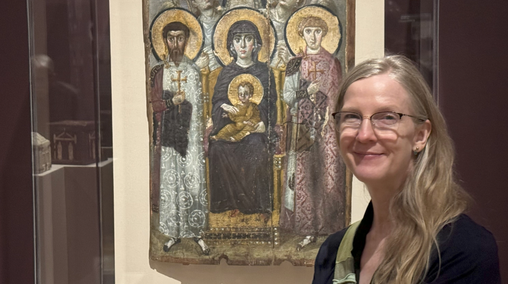 Rebecca Ruppar stands in front of a Theotokos mosaic tile